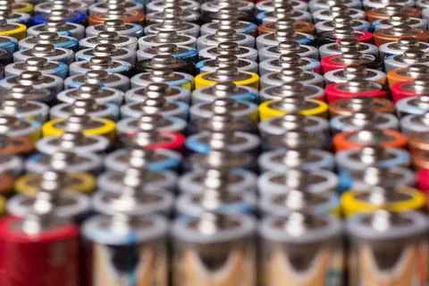 Multiple stacked aaa batteries of different color and manufacturer Stock Photos