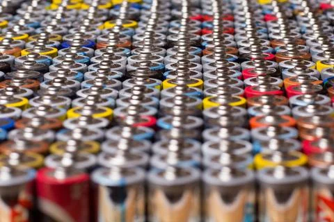 Multiple stacked aaa batteries of different color and manufacturer Stock Photos