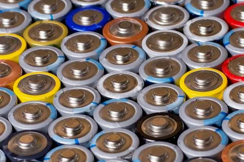 Multiple stacked aaa batteries of different color and manufacturer Foto stock