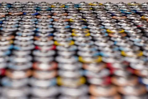 Multiple stacked aaa batteries of different color and manufacturer Stock Photos