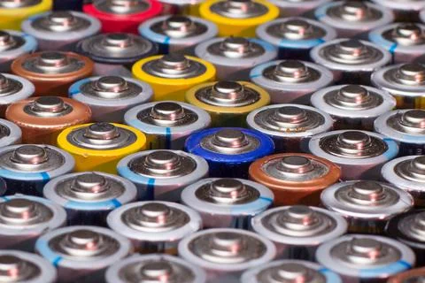 Multiple stacked aaa batteries of different color and manufacturer Stock Photos