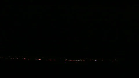 Multiple stokes of forked lightning over city and mountains Stock Footage 503740