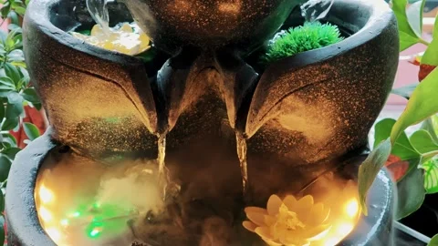 Multiple streams of water falling into a misty basin illuminated by green and Stock Footage 329307740
