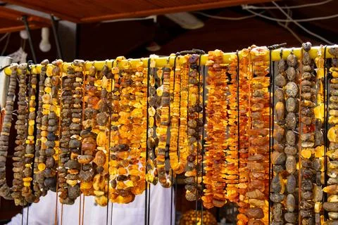 Multiple strings of raw and polished amber beads Stock Photos