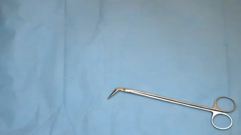 Multiple surgery instruments on blue table above view. surgeon put down surgical Stock Footage 149437532