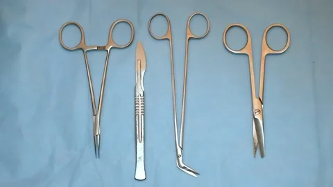 Multiple surgery instruments on blue table above view. surgeon take surgical Stock Footage 149437548