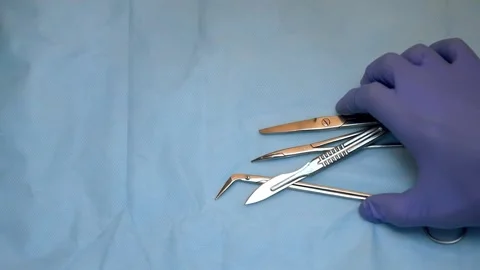 Multiple surgery instruments on blue table above view. surgeon take surgical Stock Footage 149437551