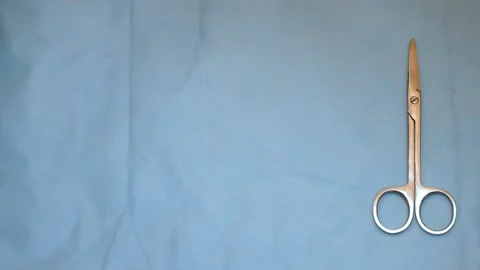 Multiple surgery instruments on blue table above view. surgeon put down surgical Stock Footage 149437580