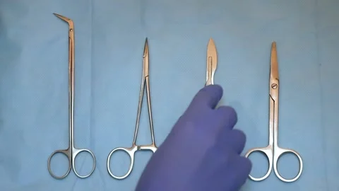 Multiple surgery instruments on blue table above view. surgeon take surgical Stock Footage 149437581
