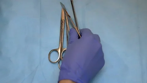 Multiple surgery instruments on blue table above view. surgeon put down surgical Stock Footage 149437612