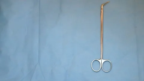 Multiple surgery instruments on blue table above view. surgeon put down surgical Stock Footage 149437635