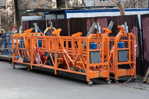 Multiple suspended scaffold platforms stand on site, showcasing industrial 写真素材