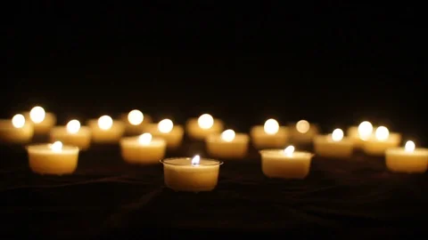 Multiple Tea Candles Burning in Darkness Stock Footage 102526548