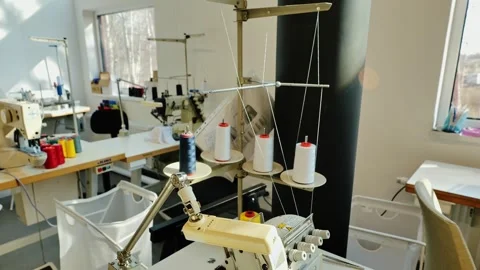 Multiple Thread Spools on Industrial Machine in Well-Lit Latvian Sewing Studio Stock Footage 307991685