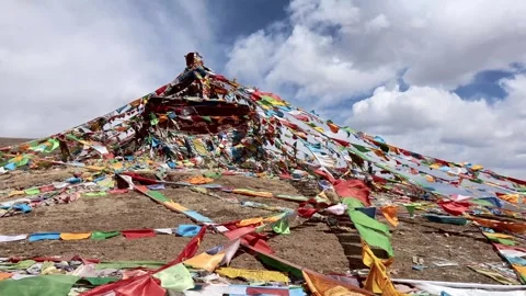 Multiple Tibetan religious prayer flags being blown with strong wind on hill 스톡 동영상 282040479