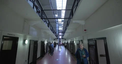 Multiple torurists visiting Crumlin Road Jail and exploring the wings and cells Stock Footage 335219376