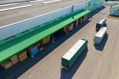 Multiple trucks loading at the factory top view. Stock Photos