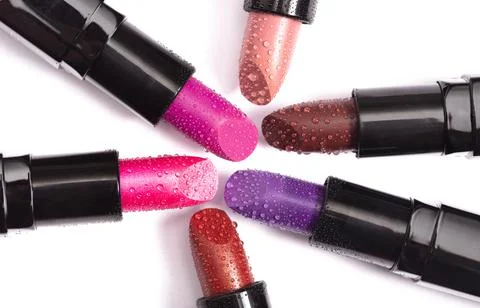 Multiple Tubes of Different Colored Lipsticks Isolated on a White Background Stock Photos