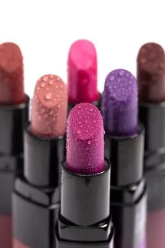 Multiple Tubes of Different Colored Lipsticks Isolated on a White Background Stock Photos
