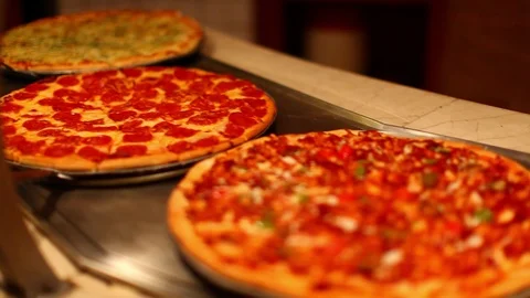 Multiple types of pizzas at self serve buffet cafeteria. cu pan A Stock Footage 107346166