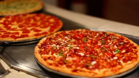 Multiple types of pizzas at self serve buffet cafeteria. cu pan B Stock Footage 107346167
