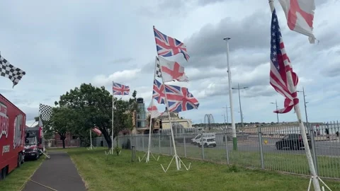 Multiple Union Jack Flags Flying Beside Road in the United Kingdom Stock Footage 337977670
