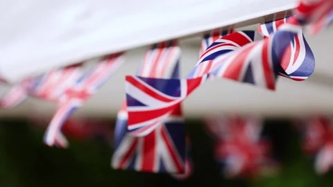 Multiple United Kingdom flags are blown by the wind during garden party 스톡 동영상 278232315
