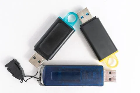 Multiple USB flash drives arranged on a white surface for storage display Stock Photos