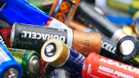 Multiple used Varta AA alkaline batteries are seen arranged in a pile. Stock Footage 120726666