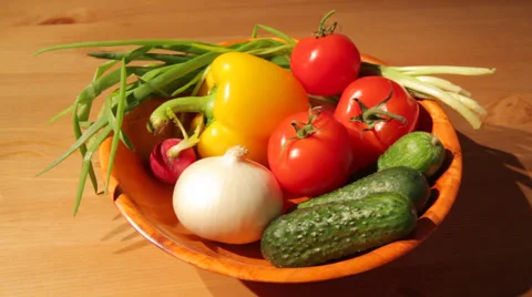 Multiple vegetables on a wooden plate Stock Footage 53285253