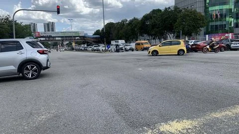 Multiple vehicles passing through a large open junction Stock Photos
