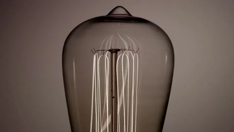 Multiple vertical edison bulb filaments glow then dim slowly Stock Footage 329656882