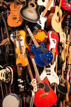 Multiple vibrant guitars on display in a museum Stock Photos