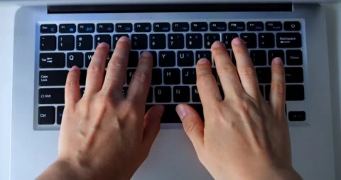 Multiple views of a programmers hands typing on a laptop keyboard, showcasing Stock Footage 316757181
