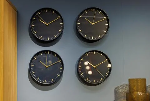 Multiple wall clocks on the wall Stock Photos