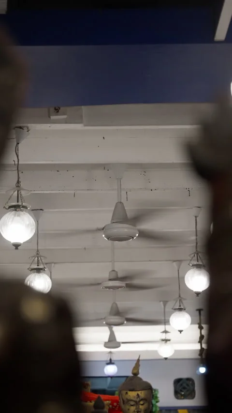 Multiple white ceiling fans and spherical pendant lights mounted on a white Stock Footage 312201616