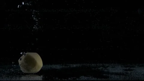 Multiple white peeled potatoes dropped falling in water with lot of splashes Stock Footage 148736704