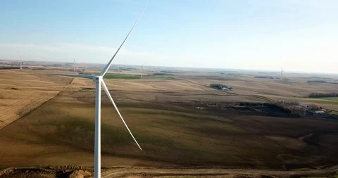 MULTIPLE WIND POWER TURBINES DRONE AERIAL 360 GORGEOUS SUN AND GREEN PASTURES Stock-Footage 111506926