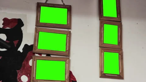Multiple Wooden Picture Frames With Green Screen Hanging on Interior Wall   Stock Footage 311483683