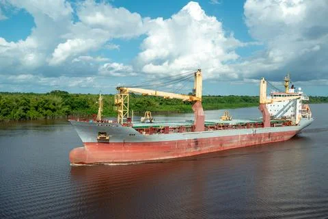 Multipurpose cargo ship underway in the river. Stock Photos