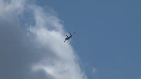Multipurpose fighter Su-35 (Flanker-E) performs aerobatics in  cloudy sky. Stock Footage 115242184