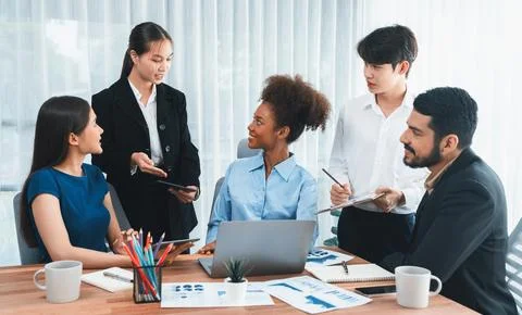 Multiracial analyst team use BI dashboard for data analysis with laptop. Concord Stock Photos