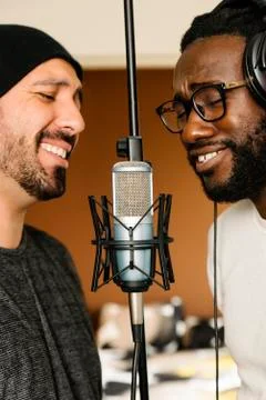 Multiracial artists singing on studio. Stock Photos
