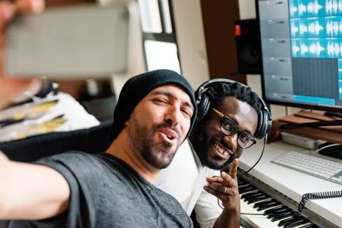 Multiracial artists taking a selfie. Stock Photos