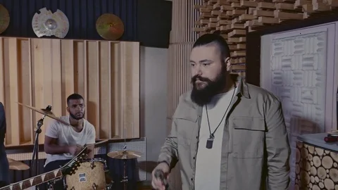 Multiracial band recording song in boutique recording studio Stock Footage