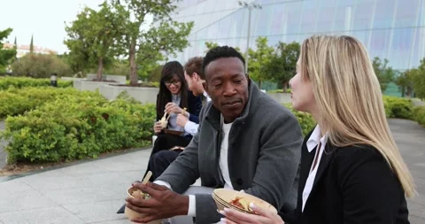 Multiracial business people doing lunch break outdoor Stock Footage 195106295