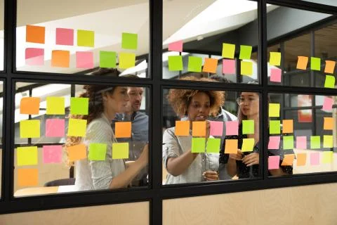 Multiracial business team brainstorm on project write on sticky notes Stock Photos