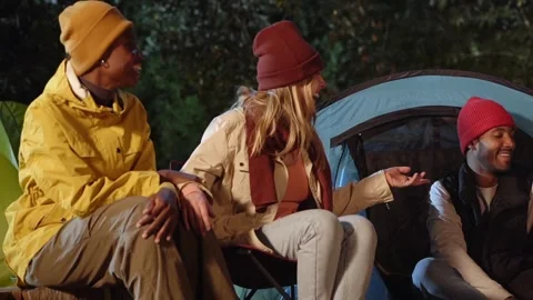 Multiracial cheerful young people talking laughing at winter camping holiday Stock Footage 257627162