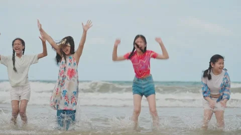Multiracial Children Jumping Together on Sandy Beach, Playing and Celebrating Stock Footage 314061283