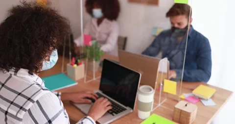 Multiracial co-workers using tablet and laptop inside creative office Stock Footage 141049919